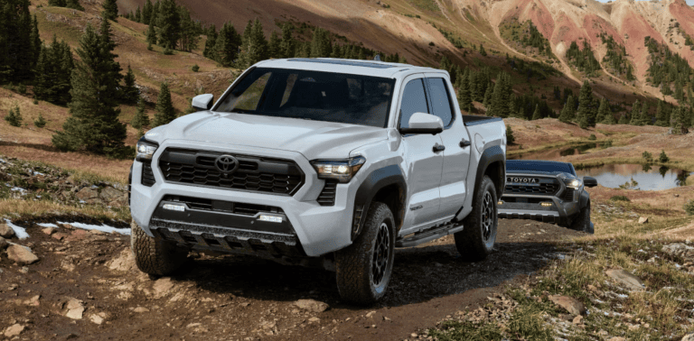 white Toyota Tacoma driving on dirt road